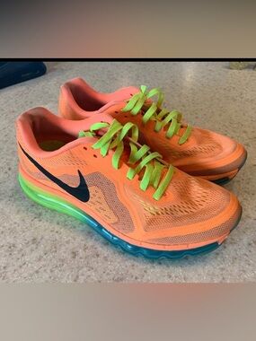 Women’s size 10 Nike Orange Running Shoes with Neon Green Laces.